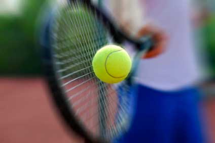 Racket hitting a tennis ball